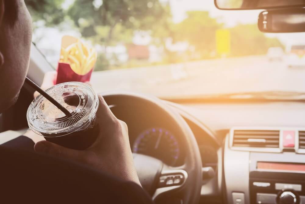 image of fleet distracted driving with a company driver eating behind the wheel