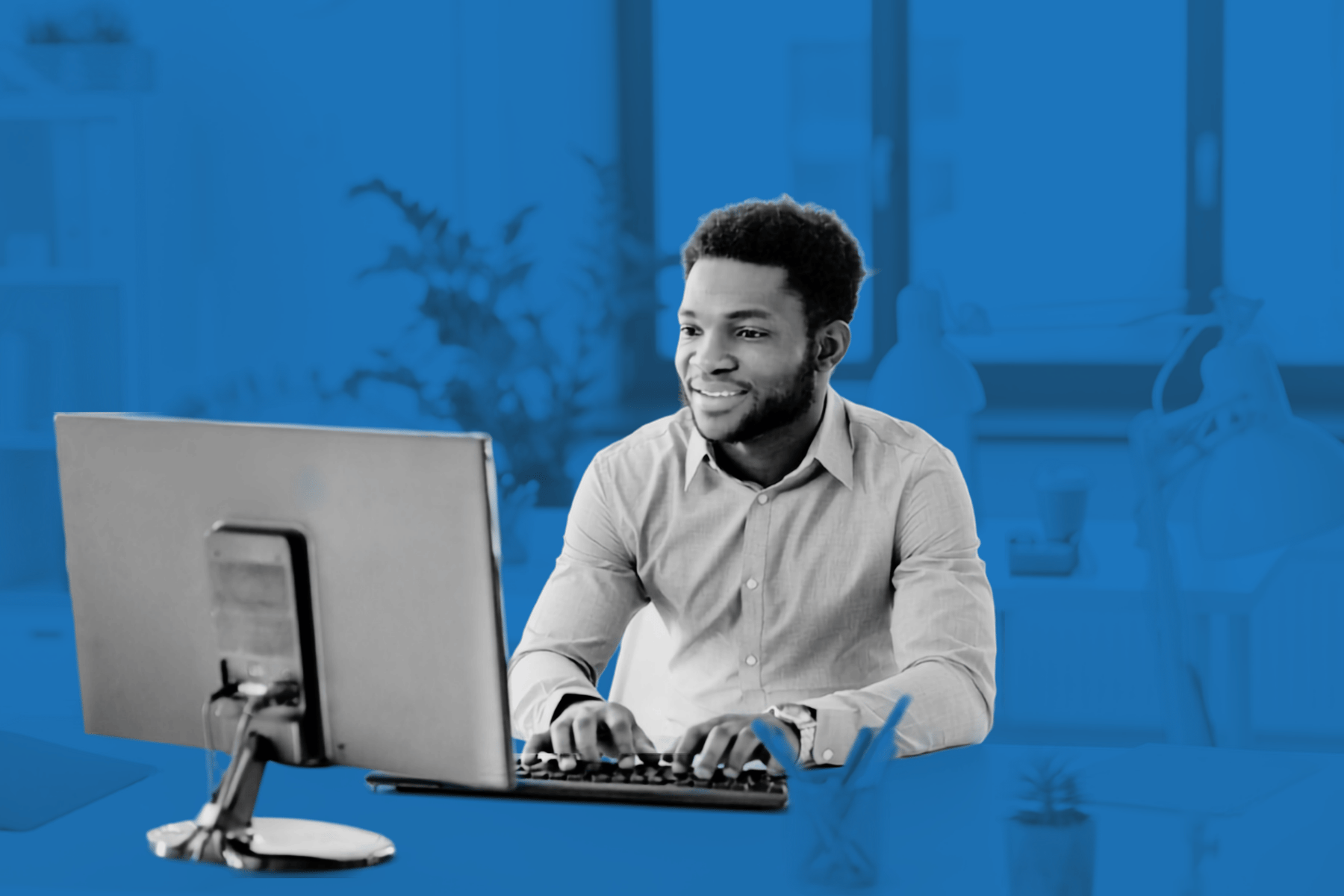 male-underwriter-typing-at-desk