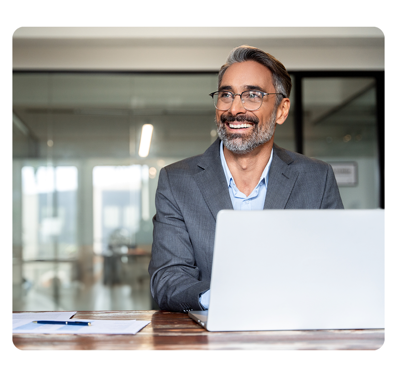 Professional at laptop smiling