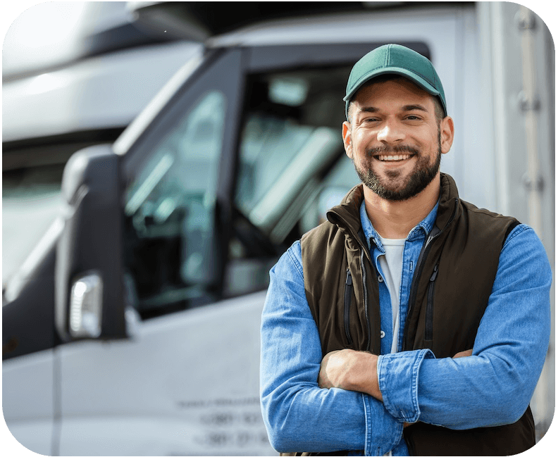 A fleet driver standing in front of a box truck