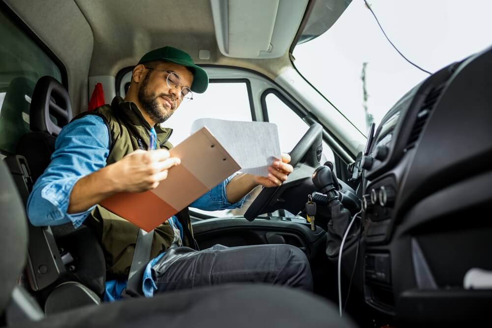 Driver reviewing a document in his truck