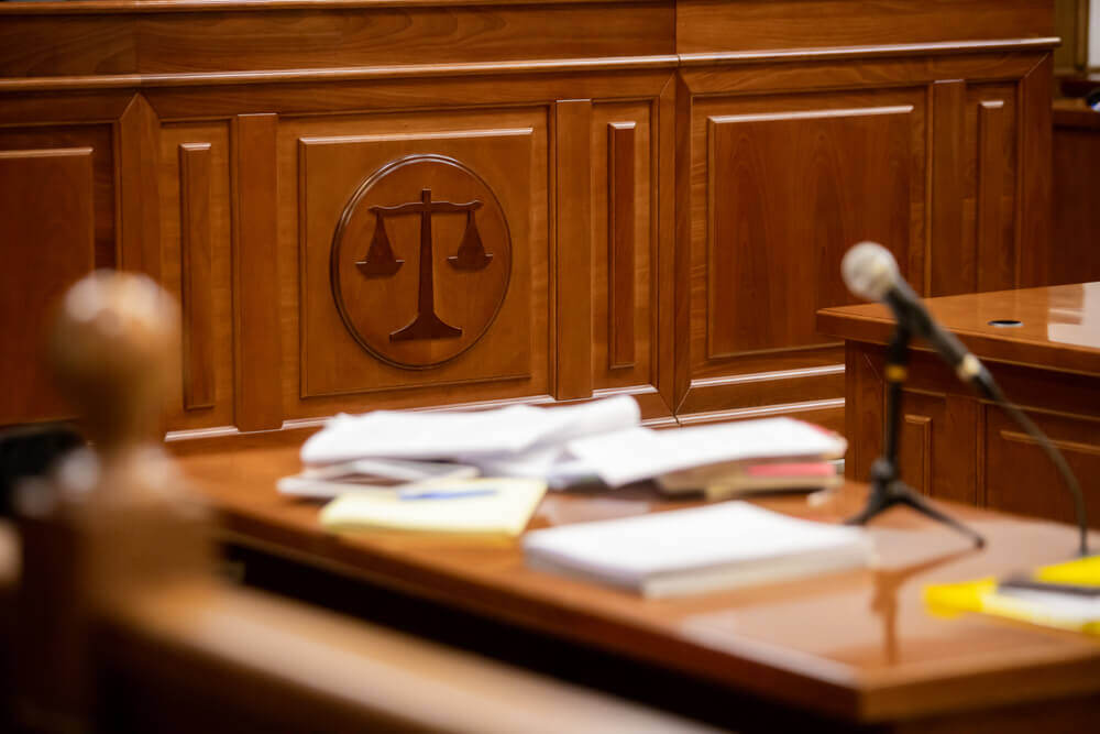 A courtroom with papers on a desk to highlight thermonuclear verdicts