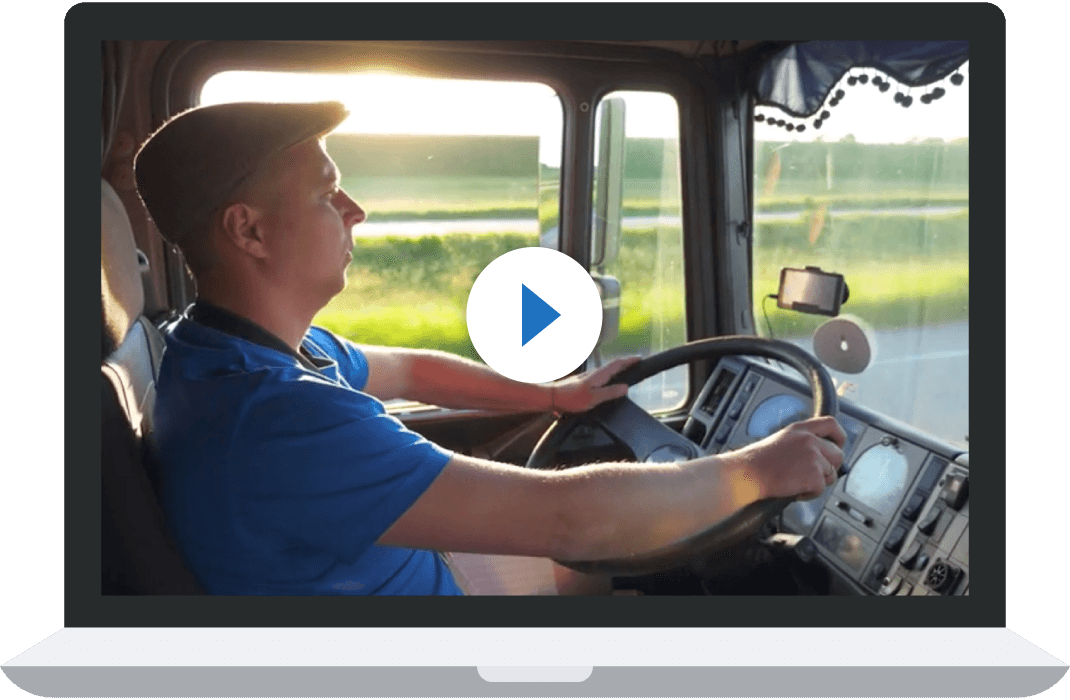 man driving truck looking at road on sunny day
